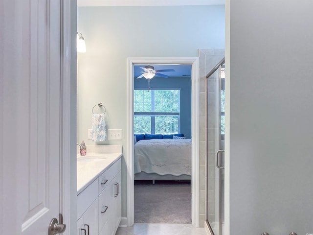 bathroom featuring tile patterned floors, ceiling fan, vanity, and walk in shower