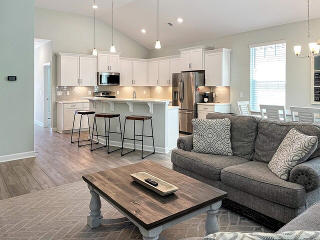 living room featuring ceiling fan and light hardwood / wood-style flooring