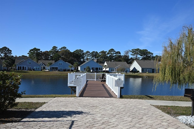 dock area with a water view and a residential view