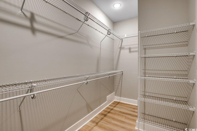 spacious closet featuring hardwood / wood-style floors