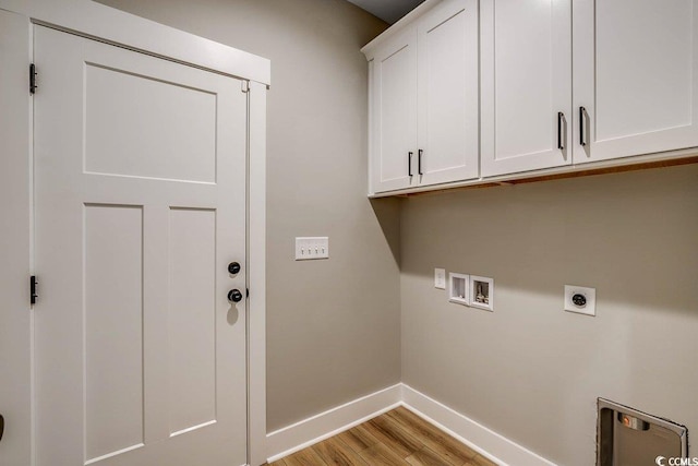 laundry area featuring light hardwood / wood-style floors, cabinets, electric dryer hookup, and hookup for a washing machine