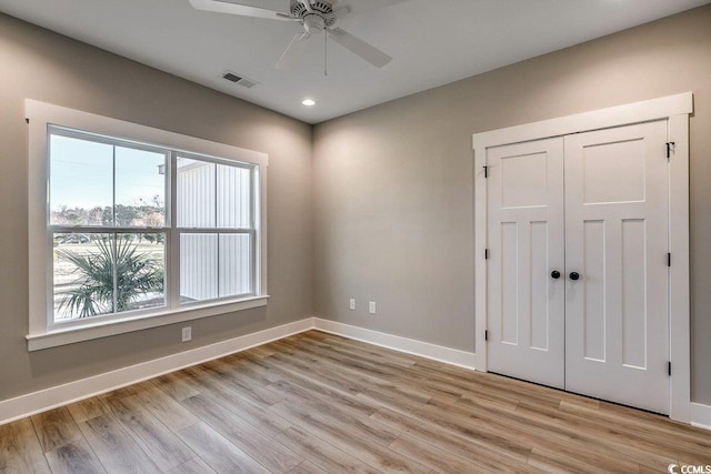 empty room featuring ceiling fan and light hardwood / wood-style floors