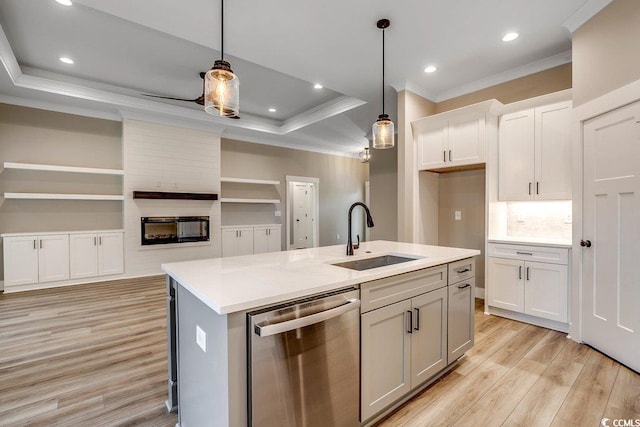 kitchen featuring a center island with sink, dishwasher, sink, and pendant lighting