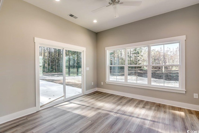 empty room featuring ceiling fan and light hardwood / wood-style flooring