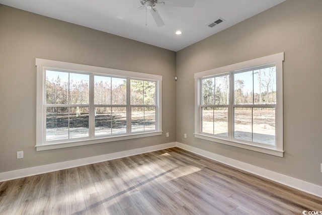 spare room featuring ceiling fan and light hardwood / wood-style flooring