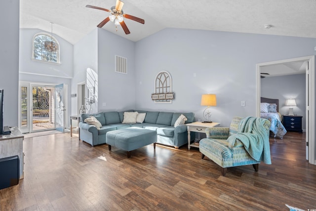 living room with ceiling fan, dark wood-type flooring, high vaulted ceiling, and a healthy amount of sunlight