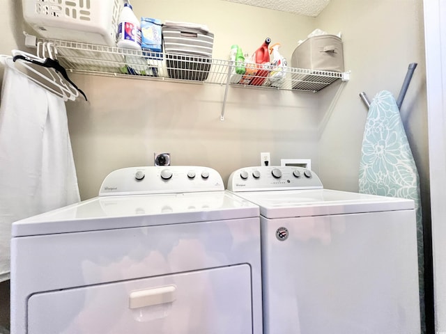 clothes washing area with washing machine and dryer