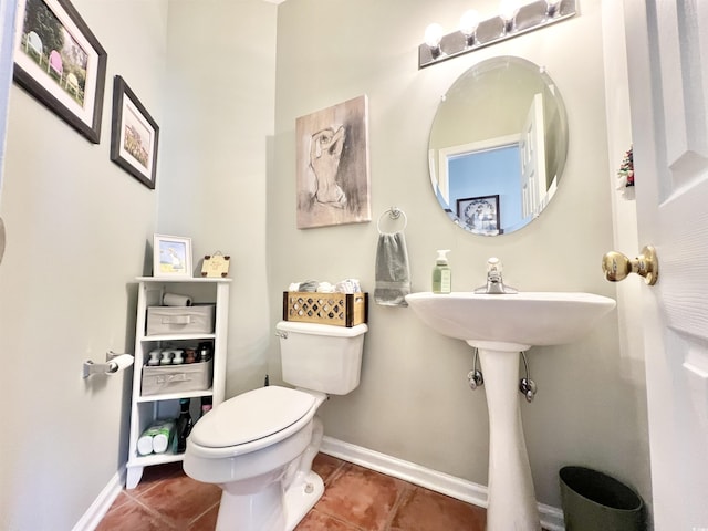 bathroom featuring tile patterned floors, toilet, and sink