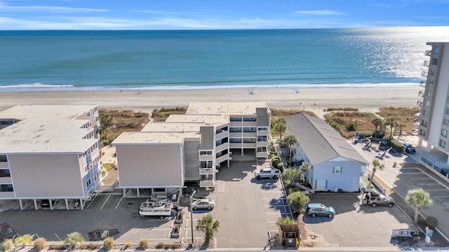 drone / aerial view featuring a water view and a view of the beach