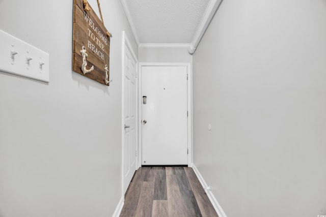 doorway featuring crown molding, hardwood / wood-style floors, and a textured ceiling