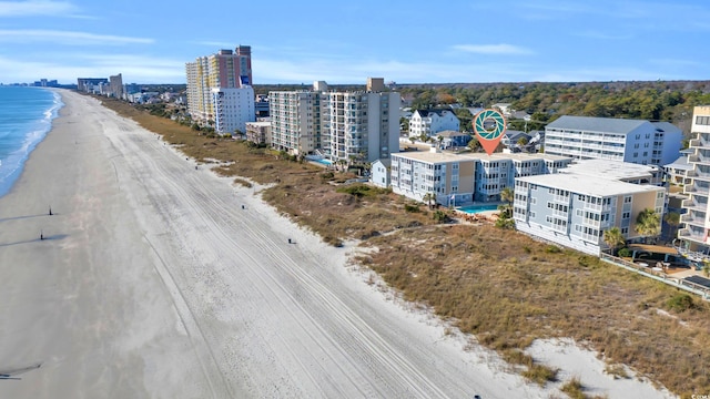 birds eye view of property with a view of the beach and a water view