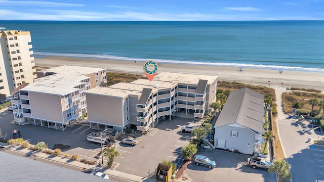 bird's eye view featuring a view of the beach and a water view