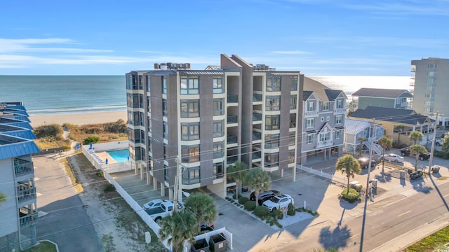 view of building exterior featuring a view of the beach and a water view