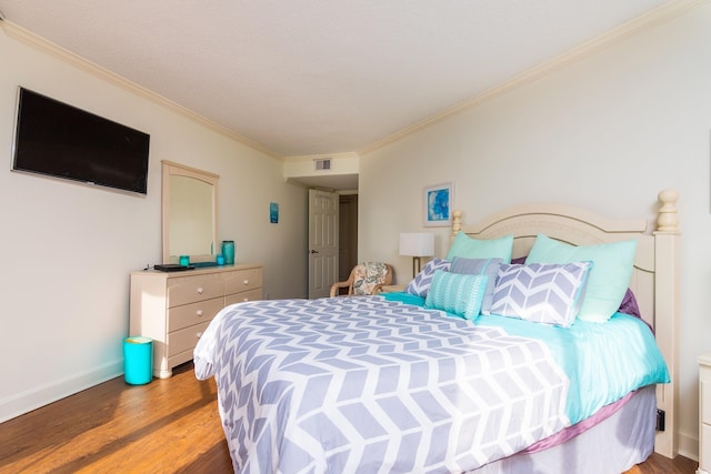 bedroom featuring wood-type flooring and ornamental molding