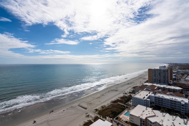 drone / aerial view featuring a water view and a view of the beach