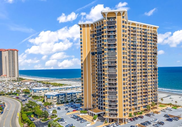 view of property with a view of the beach and a water view