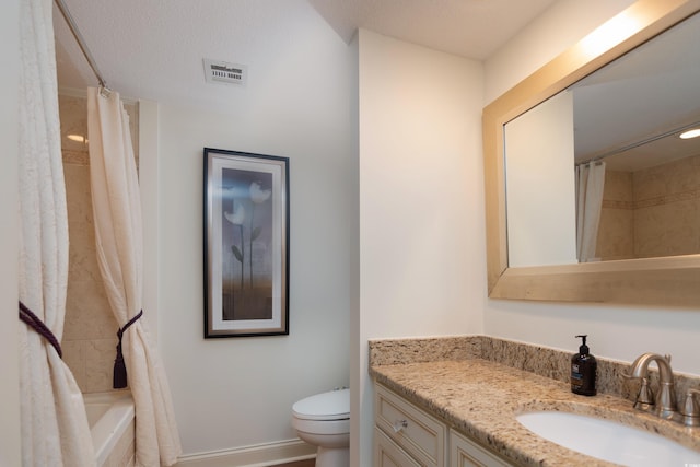 full bathroom with a textured ceiling, vanity, toilet, and shower / bath combo with shower curtain