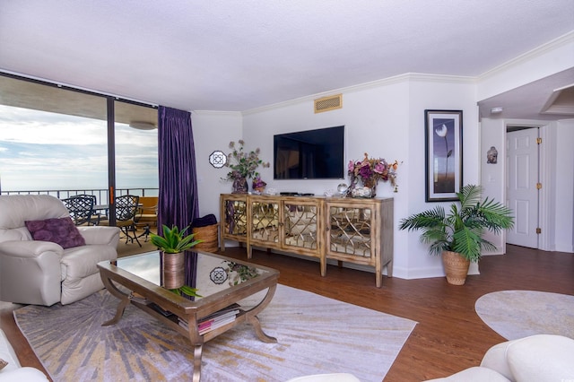 living room with dark wood-type flooring and ornamental molding