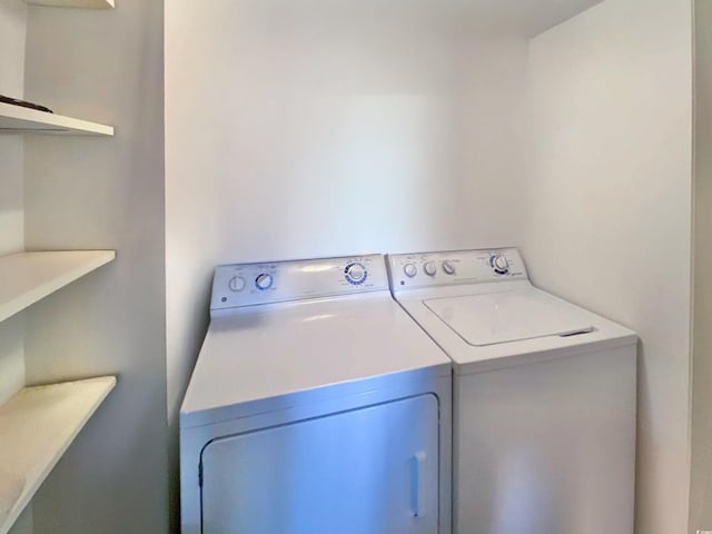 laundry room with washing machine and clothes dryer