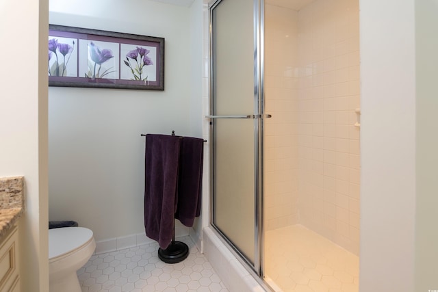 bathroom with toilet, tile patterned flooring, vanity, and walk in shower