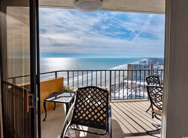 balcony with a beach view and a water view