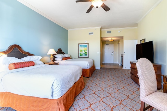 carpeted bedroom with ceiling fan and crown molding