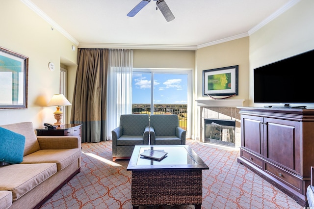 carpeted living room with crown molding, a fireplace, and ceiling fan