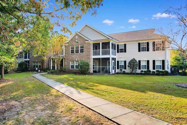 view of front of property with a front lawn and a sunroom