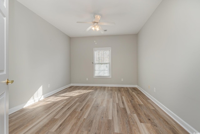 empty room with ceiling fan and light wood-type flooring