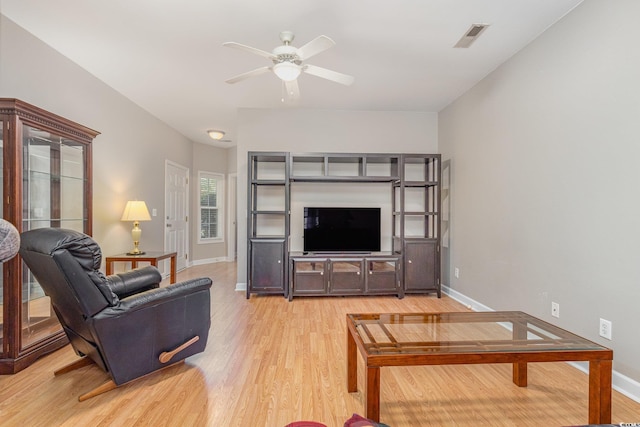 living room featuring ceiling fan and light hardwood / wood-style flooring