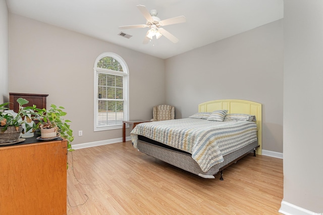 bedroom with ceiling fan and hardwood / wood-style flooring