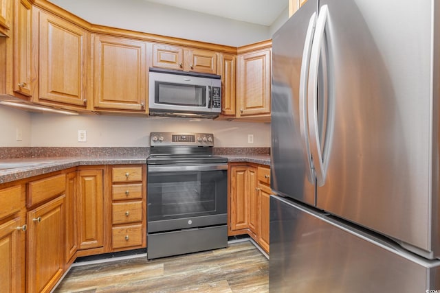 kitchen featuring appliances with stainless steel finishes and light wood-type flooring