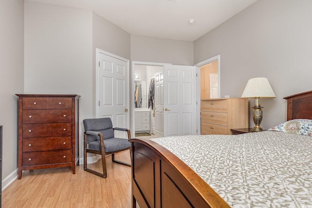 bedroom featuring light wood-type flooring, a closet, and connected bathroom