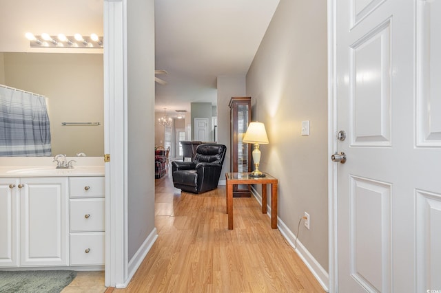 hallway featuring light hardwood / wood-style floors and sink