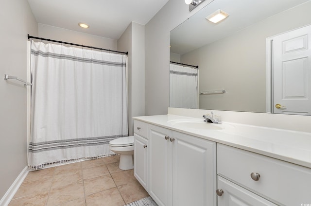 bathroom with toilet, vanity, and tile patterned floors