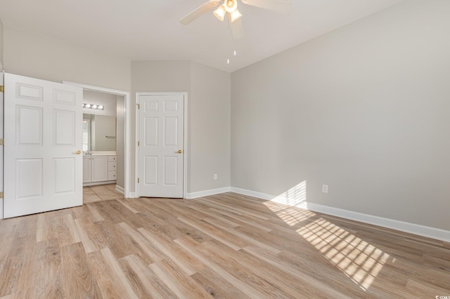 unfurnished bedroom with ensuite bathroom, ceiling fan, and light hardwood / wood-style floors