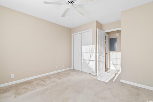 carpeted empty room with ceiling fan and electric panel