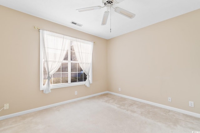 carpeted empty room featuring ceiling fan