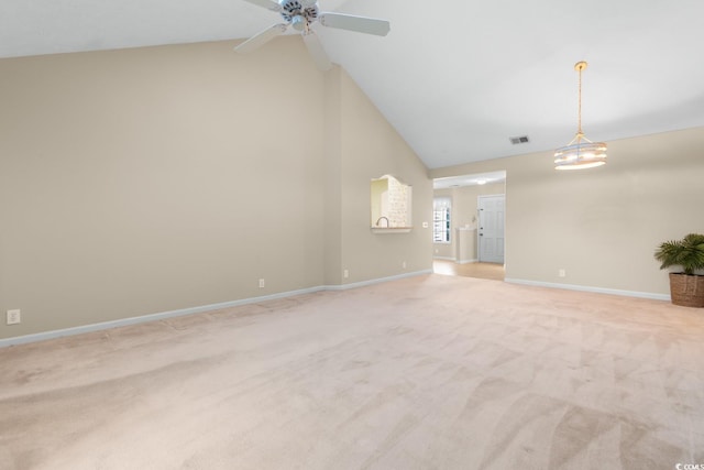 unfurnished living room with light colored carpet and high vaulted ceiling