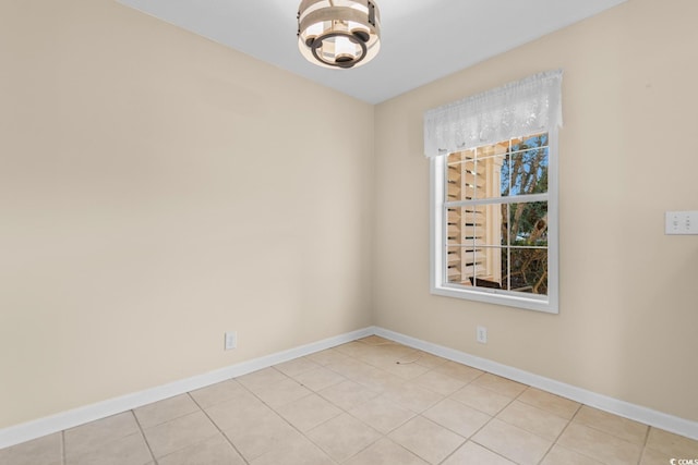 unfurnished room with light tile patterned floors and a notable chandelier