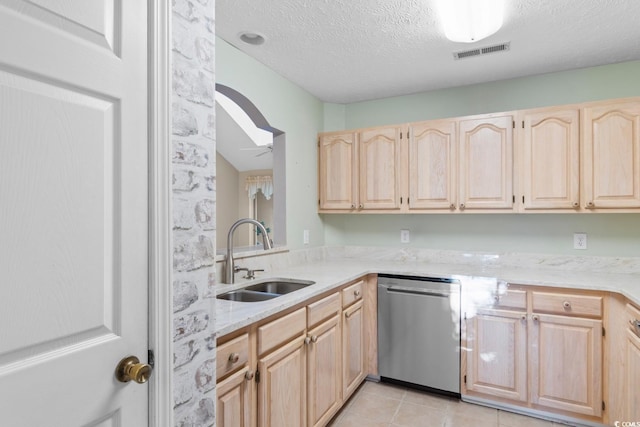 kitchen with light brown cabinetry, ceiling fan, sink, dishwasher, and light tile patterned flooring