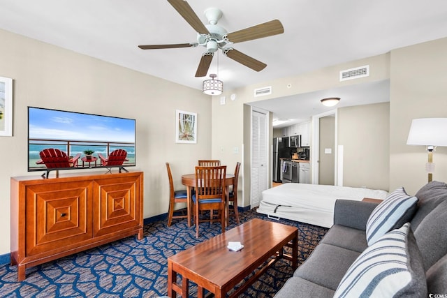 living room with dark carpet and ceiling fan