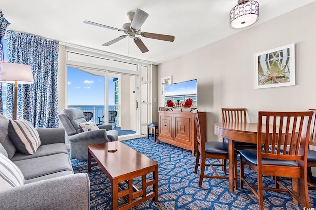 carpeted living room with ceiling fan