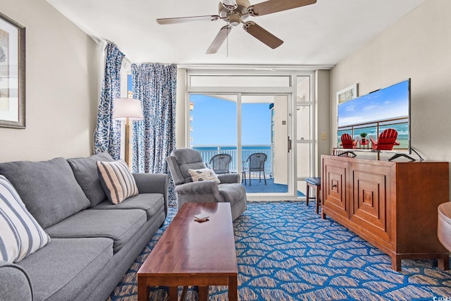 living room featuring dark colored carpet and ceiling fan