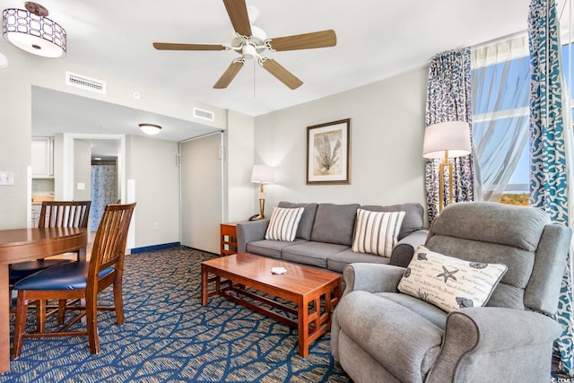 living room with ceiling fan and carpet floors