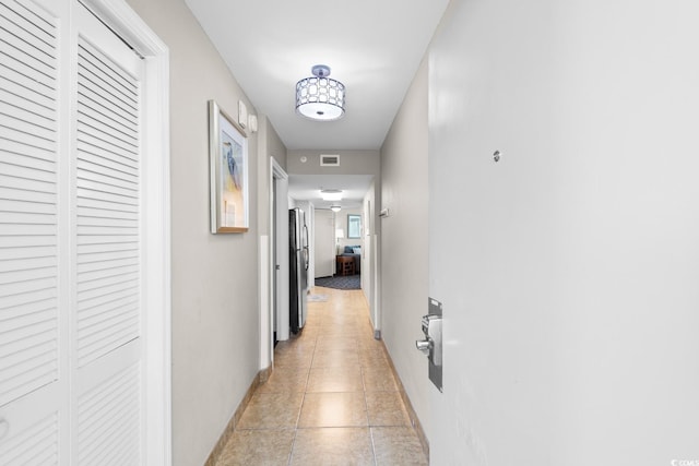 hall with light tile patterned flooring