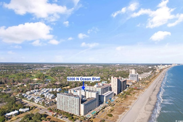 birds eye view of property with a water view and a view of the beach