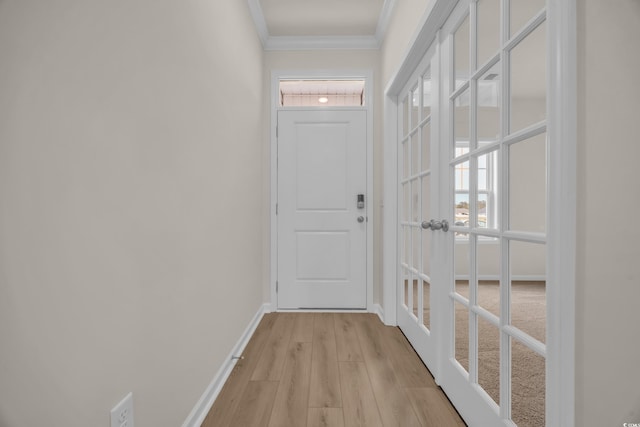 doorway featuring ornamental molding, plenty of natural light, light wood finished floors, baseboards, and french doors