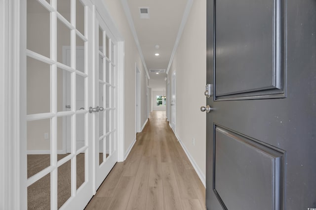 hall with light wood-type flooring, crown molding, baseboards, french doors, and recessed lighting