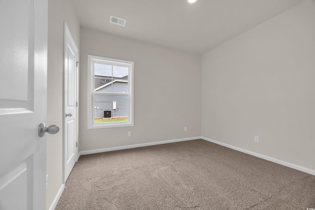 spare room with carpet flooring and baseboards